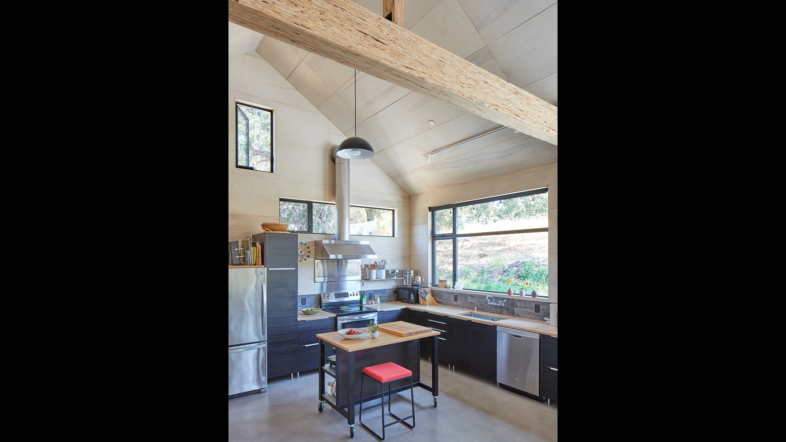 Green-Building-Sonoma-County-ADU-4-black-and-light-brown-wood-kitchen-with-large-windows